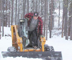 Les Rolston taking a break from ploughing the road at Ginty Creek