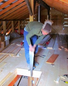 Mogens handsawing a piece to complete the attic floor