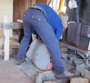 The stone oven floor is being moved into place