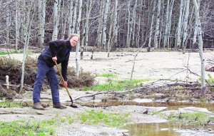 shovelling sand from the flood deposits beside the McClinchy River