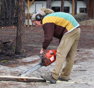 Mogens chain sawing a piece to fit the attic floor around the top of the steps. steps