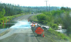 road flooded by excessive rain